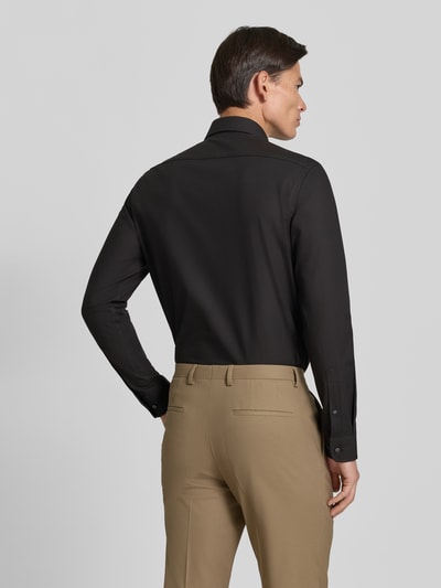 Männermodel trägt Regular Fit Business-Hemd mit Kentkragen von Christian Berg Men, Baumwoll-Mix, schwarze Farbe, Ganzkörperansicht Rückansicht.