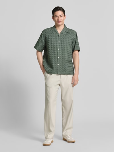 Männermodel trägt Relaxed Fit Freizeithemd aus reiner Baumwolle Modell 'MONTY' von SELECTED HOMME, Optik: Unifarben, Kurzarm, Jacquard, Ganzkörperansicht von vorne.