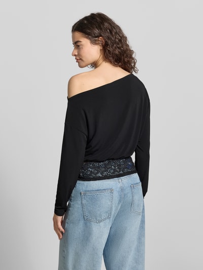 Vrouwenmodel draagt shirt met lange mouwen met asymmetrische hals en kant, model 'Mirelin' van Gina Tricot, materiaalmix met stretch, nauwsluitend model, zwarte kleur, ruglengte bij maat S 52 cm, detailopname rugaanzicht.