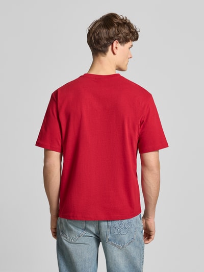 Männermodel trägt T-Shirt mit Label-Print und Rundhalsausschnitt von REVIEW in Rot, reine Baumwolle, Regular Fit, Ganzkörperansicht Rückansicht