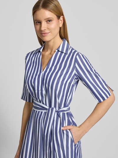 Modelka nosi sukienkę koszulową 'Knielanges Hemdblusenkleid mit Bindegürtel' z bawełny marki WHITE LABEL w białe i niebieskie paski, prosty krój, dekolt w serek, wiązany pasek, długość do kolan, szerokość w rozmiarze 36: 53 cm, długość tyłu: 102 cm, długość rękawów: 33 cm, zbliżenie na górną część ciała z przodu.