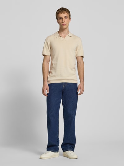 Männermodel trägt Regular Fit Poloshirt in Strick-Optik Modell 'Bray' von Blend, Reine Baumwolle, Kurzärmelig, Beige und Blau, Ganzkörperansicht von vorne.