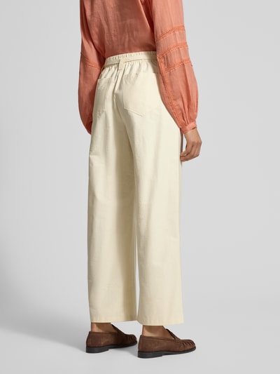 Modelka nosi Hose mit elastischem Bund und Bindegürtel od JAKE*S STUDIO WOMAN, krój wide fit, kieszenie z tyłu, beżowy, Szerokość w rozmiarze 36: 38 cm, Długość nogawki od wewnątrz w rozmiarze 36: 72 cm, widok całej sylwetki z tyłu.