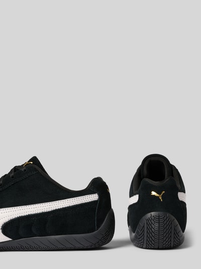 Produktfoto, Sneaker aus echtem Leder Modell 'Speedcat' von PUMA in Schwarz mit weißem Logo-Detail, glatter Sohle, abgerundeter Passform.