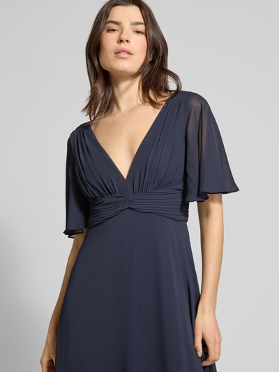 Frauenmodel trägt Regular Fit Abendkleid mit V-Ausschnitt von Jake*s Cocktail in Dunkelblau, Chiffon, Halbarm, Falten-Optik, Nahaufnahme Oberkörper.
