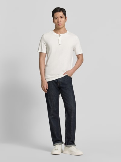 Männermodel trägt Regular Fit T-Shirt aus reiner Baumwolle von s.Oliver RED LABEL in Optik: Unifarben, Henley-Kragen, Ganzkörperansicht von vorne.