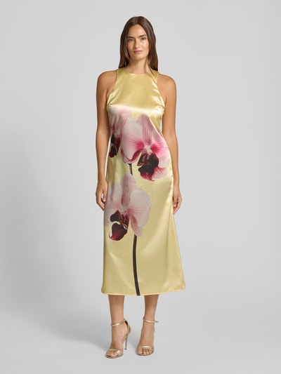 Frauenmodel trägt Cocktailkleid aus Satin mit Motiv-Print von YAS, A-Linie, Rundhalsausschnitt, Midikleid, Ganzkörperansicht von vorne.