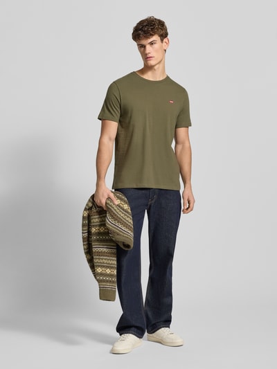 Männermodel trägt Jeans mit 5-Pocket-Design von Levi's®, Reine Baumwolle, Slim-Fit, dunkelblauer Denim, Ganzkörperansicht von vorne.