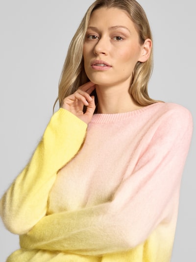 Frauenmodel trägt Regular Fit Pullover aus Kaschmir-Mix in Strick-Optik von HERZENS, Pastell-Gelb und Rosa, Rundhalsausschnitt, Nahaufnahme Oberkörper. Damenpullover mit Woll-Anteil, elastische Abschlüsse, Rückenlänge 59 cm, Ärmellänge 54 cm bei Größe 36.