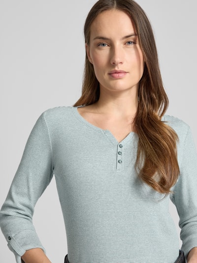 Vrouwenmodel draagt Regular Fit Langarmshirt aus Baumwoll-Mix van Tom Tailor, two tone effen ribbreisel, V-hals, label stitching, katoenmix. Nahaufnahme bovenlichaam.