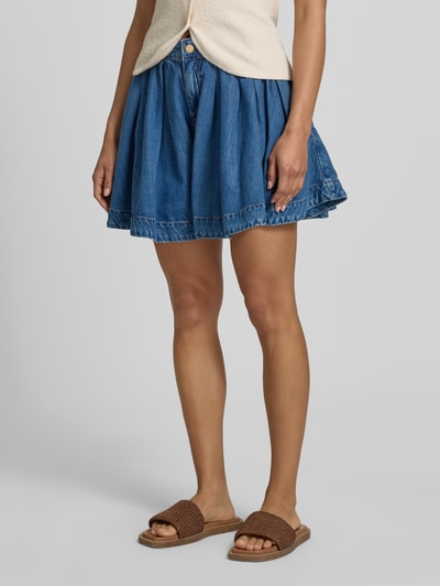 Frauenmodel trägt Regular Fit Jeansshorts aus Lyocell-Baumwoll-Mix Modell 'JOSS' von Essentiel Antwerp in Denim-Optik mit Label-Patch, Gürtelschlaufen, Knopf und verdecktem Reißverschluss, seitliche Eingrifftaschen, Twill-Materialverarbeitung, Ganzkörperansicht von vorne.