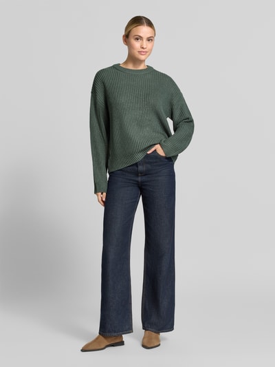 Vrouwenmodel draagt groene regular fit pullover met crew neck model 'LEA' van VERO MODA, donkere jeans, Ganzkörperaanzicht van voren.