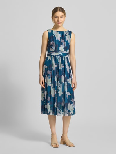 Frauenmodel trägt Cocktailkleid mit Taillenband von Christian Berg Cocktail aus Elastischer-Material-Mix, Taillierte Passform, Midikleid, Rundhalsausschnitt, Taillenband, Raffungen, Rückenlänge 123 cm, Brustweite 44 cm, florales Muster in Blau und Pastell, Ganzkörperansicht von vorne.