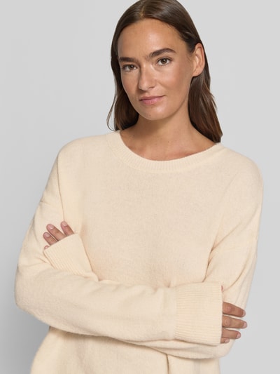 Vrouwenmodel draagt gebreide pullover met kant en ronde hals van Milano Italy, materiaalmix met alpaca, relaxed fit, crèmekleurig, close-up bovenlichaam.