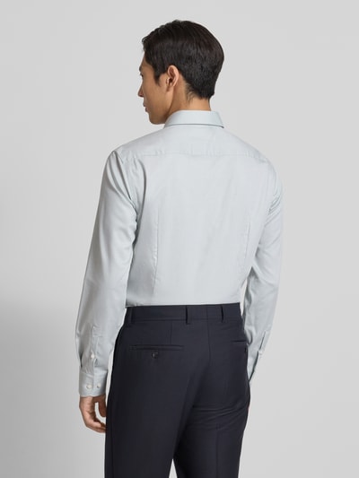 Męski model nosi Slim Fit Businesshemd aus Baumwoll-Mix Modell 'HANK' von BOSS, efekt: jednolity kolor, faktura, długi rękaw, kołnierzyk typu kent, regulowane mankiety na 1 guzik, łatwe prasowanie, widok całej sylwetki z tyłu.