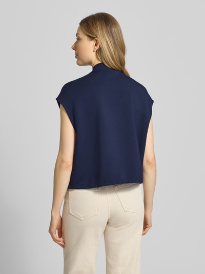 Frauenmodel trägt Regular Fit Weste mit Stehkragen von Christian Berg Woman aus Elastischer-Material-Mix mit Modal-Mix in Dunkelblau, Eingrifftaschen, Reißverschluss, Tunnelzug im Bund, Ganzkörperansicht Rückansicht.