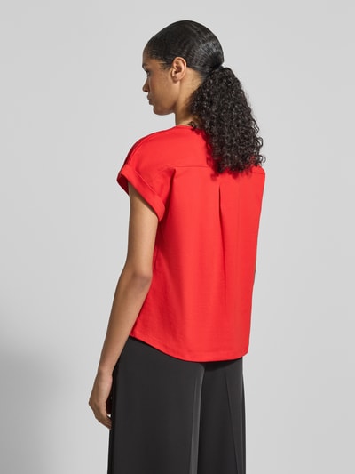 Männermodel trägt Relaxed Fit T-Shirt mit Logo-Applikation Modell 'Pima' von monari, kolor czerwony, okrągły dekolt, długość pleców 50 cm w rozmiarze 36, całkowity widok z tyłu.