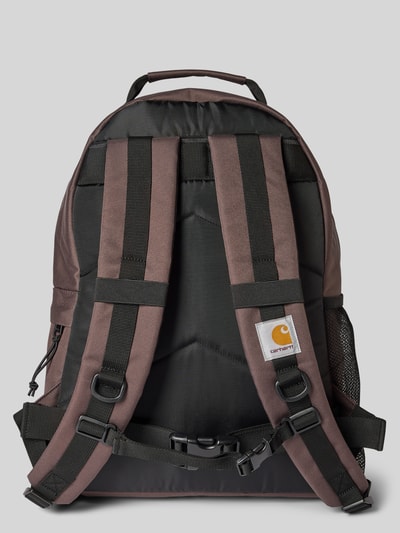 Productfoto, Rucksack met label-details model 'KICKFLIP' van Carhartt Work In Progress in zwart-bruin met brede verstelbare schouderriem, buitenvakken, kliksluitingen, korte draaghengsel, hoofdvak met rondom rits, binnenvak, afmetingen 36x48x18 cm, schouderriem 63 cm.