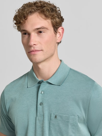 Männermodel trägt Relaxed Fit Poloshirt aus Baumwoll-Mix von RAGMAN in Mintgrün, Brusttasche mit Label, Nahaufnahme Oberkörper.