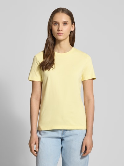 Modelka kobieca nosi T-Shirt mit Rundhalsausschnitt und Label-Stitching von Calvin Klein Jeans, bawełna, krój regular fit, żółty, całkowity widok z przodu.