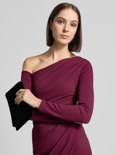 Frauenmodel trägt Clutch aus Leder mit Reißverschlussfach innen von Abro in Schwarz, matte Textur, Outfit in Dunkelrot, Nahaufnahme Oberkörper. Hauptfach mit Umschlag, Magnetverschluss, Label-Detail innen, Breite 23 cm, Länge 14 cm, Tiefe 4 cm.