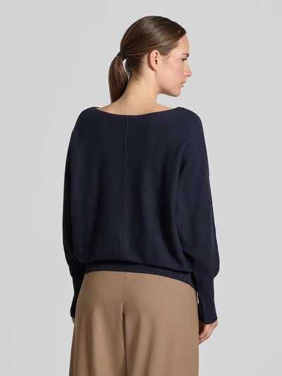Frauenmodel trägt Strickpullover aus Viskose-Mix von MORE & MORE in Dunkelblau, lockere Passform, breite Rippbündchen, Ganzkörperansicht Rückansicht.