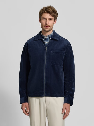 Männermodel trägt Regular Fit Hemdjacke aus Cord mit Brusttasche von MCNEAL in Dunkelblau, Kentkragen, Reißverschluss, Ganzkörperansicht von vorne. Baumwoll-Elasthan-Mix, Rückenlänge bei Größe M 70 cm.
