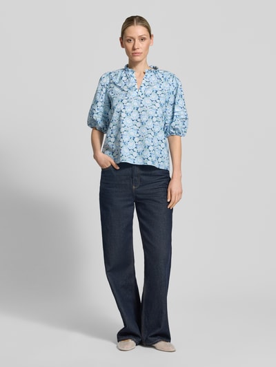 Frauenmodel trägt Bluse mit Serafino-Kragen und Ballonärmeln von Rich & Royal in Blau, Reine Baumwolle, Loose-Fit, Ganzkörperansicht von vorne.