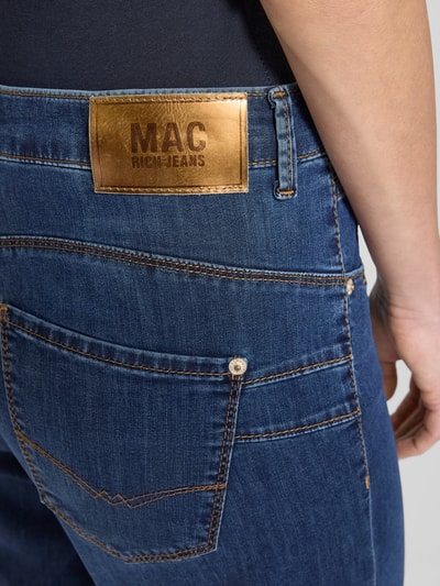 Mężczyznamodel nosi Jeans mit 5-Pocket-Design od MAC, niebieski bawełniany miks z dodatkiem stretchu, luźny krój, detal tylnej kieszeni, szerokość w rozmiarze 36/32: 41 cm, długość nogawki wewnętrznej: 81 cm, zbliżenie na tył