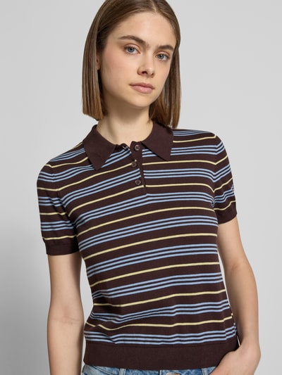 Frauenmodel trägt Regular Fit Polo-Strickshirt mit Streifenmuster von REVIEW in Braun, Gelb und Blau aus reiner Baumwolle, Nahaufnahme Oberkörper.