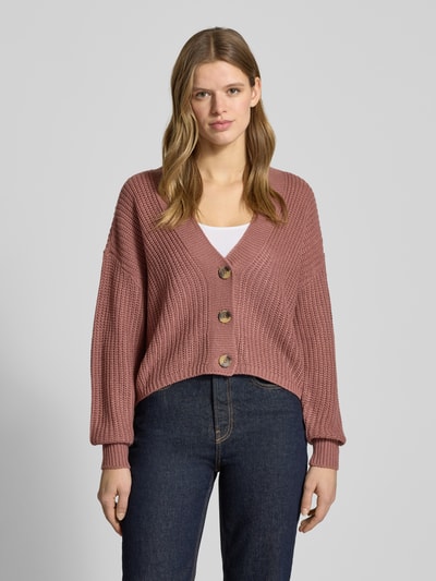 Frauenmodel trägt Regular Fit Strickjacke mit einreihiger Knopfleiste Modell 'CAROL NICE' von Only, altrosa, Strickoptik, Ganzkörperansicht von vorne.