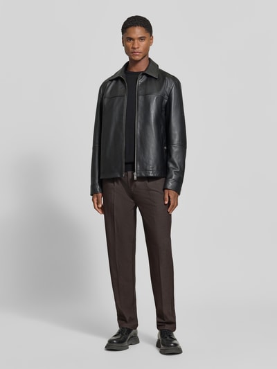 Männermodel trägt Stoffhose mit Bügelfalte Modell 'MARC' von Casual Friday in Braun, Straight Fit, elastischer Bund, Ganzkörperansicht von vorne.