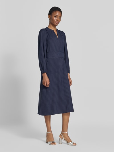 Frauenmodel trägt Midikleid mit Viskose-Anteil und Taillenband Modell 'Paris' von LOLLYS LAUNDRY in Navy, feine Streifen, Langarm, Ganzkörperansicht von vorne.