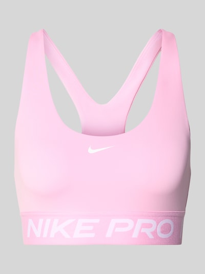 Produktfoto, Sport-BH mit Label-Bund von Nike in Rosa mit glatter Textur und weißem Logo auf hellgrauem Hintergrund, Damen Sport-BH von Nike