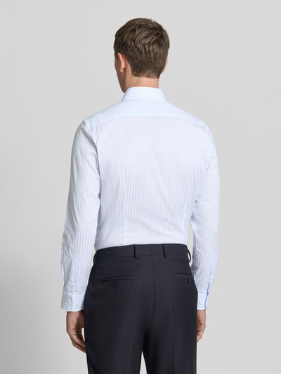 Männermodel trägt Slim Fit Businesshemd aus Baumwoll-Mix von Tommy Hilfiger Tailored mit dezentem Streifenmuster, Ganzkörperansicht Rückansicht.
