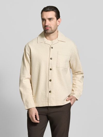 Männermodel trägt Relaxed Fit Freizeithemd aus reiner Baumwolle Modell 'RLXRAY' von SELECTED HOMME in unifarbener Struktur, Ganzkörperansicht von vorne.