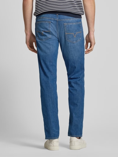 Männermodel trägt Modern Fit Jeans mit Karabiner Modell 'Mitch' von JOOP! Jeans aus Baumwoll-Mix mit Stretch-Anteil, Farbe Mittelblau, sichtbare Eingrifftaschen, glatte Textur, Herren Jeans, Ganzkörperansicht Rückansicht.