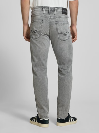 Männermodel trägt Slim Fit Jeans im Used-Look Modell 'Anbass' von Replay in Grau, 5-Pocket-Design, elastischer Baumwoll-Mix, Rückansicht Ganzkörperansicht.