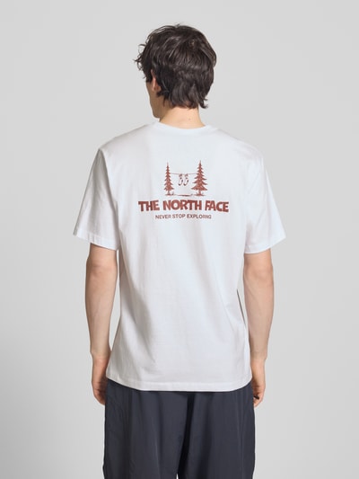Männermodel trägt Relaxed Fit T-Shirt mit Logo-Print von The North Face in Weiß, reine Baumwolle, Rundhalsausschnitt, Rückansicht, Ganzkörperansicht.