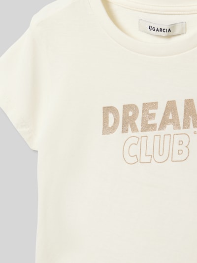 Mädchen trägt Regular Fit T-Shirt mit Statement-Print von Garcia, reine Baumwolle, Glitzer-Optik, Nahaufnahme Oberkörper.