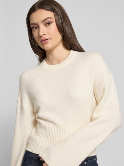 Frauenmodel trägt Strickpullover mit weiten Ärmeln Modell 'Stella' von Gina Tricot, cremefarben, Alpaka-Mix, Regular-Fit, Nahaufnahme Oberkörper.