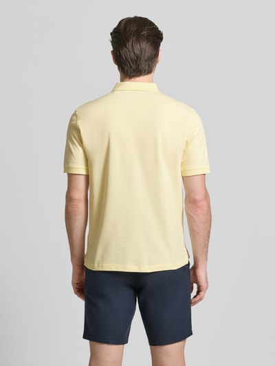 Männermodel trägt Regular Fit Poloshirt mit Logo-Stitching von Gant in Hellgelb, elastischer Baumwoll-Mix, Ganzkörperansicht Rückansicht