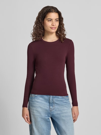 Frauenmodel trägt Regular Fit Langarmshirt aus Baumwoll-Mix Modell 'RILEY' von ONLY in Dunkelrot, glatte Textur, Ganzkörperansicht von vorne, Damen Langarmshirt von ONLY.