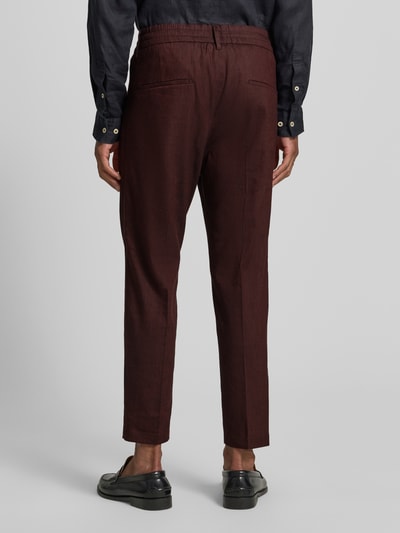 Männermodel trägt Hose aus Leinen-Mix mit Gesäßtaschen von Drykorn, Slim-Fit, elastischer Bund, Ganzkörperansicht Rückansicht.