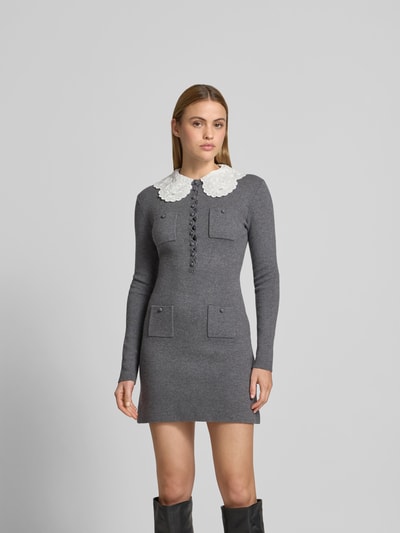 Frauenmodel trägt Minikleid mit Woll-Anteil von Self-Portrait in Grau mit weißem Kragen, Strick-Optik, taillierte Passform, aufgesetzte Taschen, langärmelig, Ganzkörperansicht von vorne.