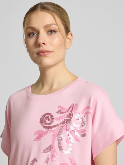 Frauenmodel trägt T-Shirt aus Viskose-Mix mit Pailletten von Milano Italy in Rosa, Rundhalsausschnitt, Regular Fit, Nahaufnahme Oberkörper.