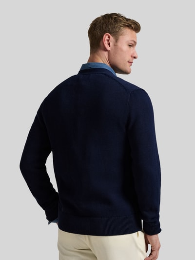 Männermodel trägt Regular Fit Strickjacke aus reiner Baumwolle von Polo Ralph Lauren, dunkelblau, einfarbig, Strickstruktur, Ganzkörperansicht Rückansicht.