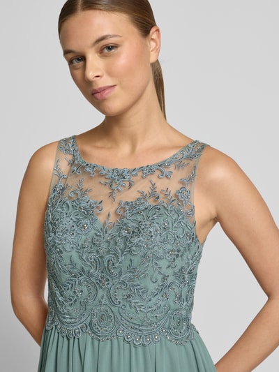 Frauenmodel trägt Abendkleid mit Ziersteinen und Floralen-Stickereien von LAONA, Rundhalsausschnitt, Tailliert, Nahaufnahme Oberkörper.