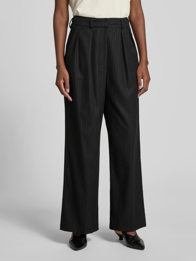 Frauenmodel trägt Wide Fit Hose mit Viskose-Anteil von black palms, Dunkel und gestreift, Elastischer-Material-Mix, Bundfalten, Gesäßtasche, Haken-Reißverschluss, Ganzkörperansicht von vorne.