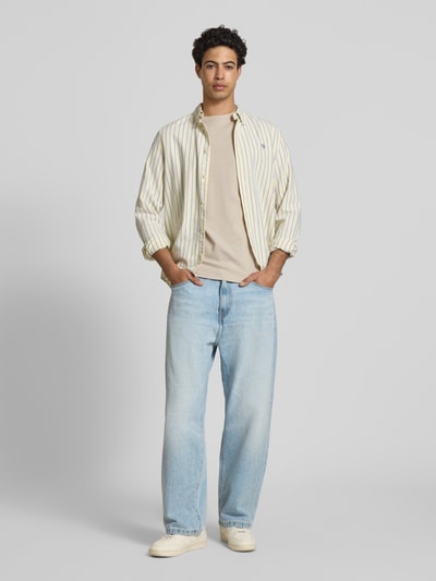 Männermodel trägt Regular Fit T-Shirt aus reiner Baumwolle Modell 'CASPIAN AIRFLEX AMORE' von Only & Sons in Unifarbe mit Rundhalsausschnitt, kühlend, atmungsaktiv, feuchtigkeitsregulierend, Ganzkörperansicht von vorne.